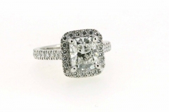 Handmade platinum cushion cut engagement ring featuring a diamond halo and band