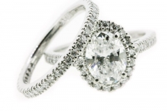Custom Designed 1.5ct oval cut diamond, set in a halo style with matching diamond set wedding band