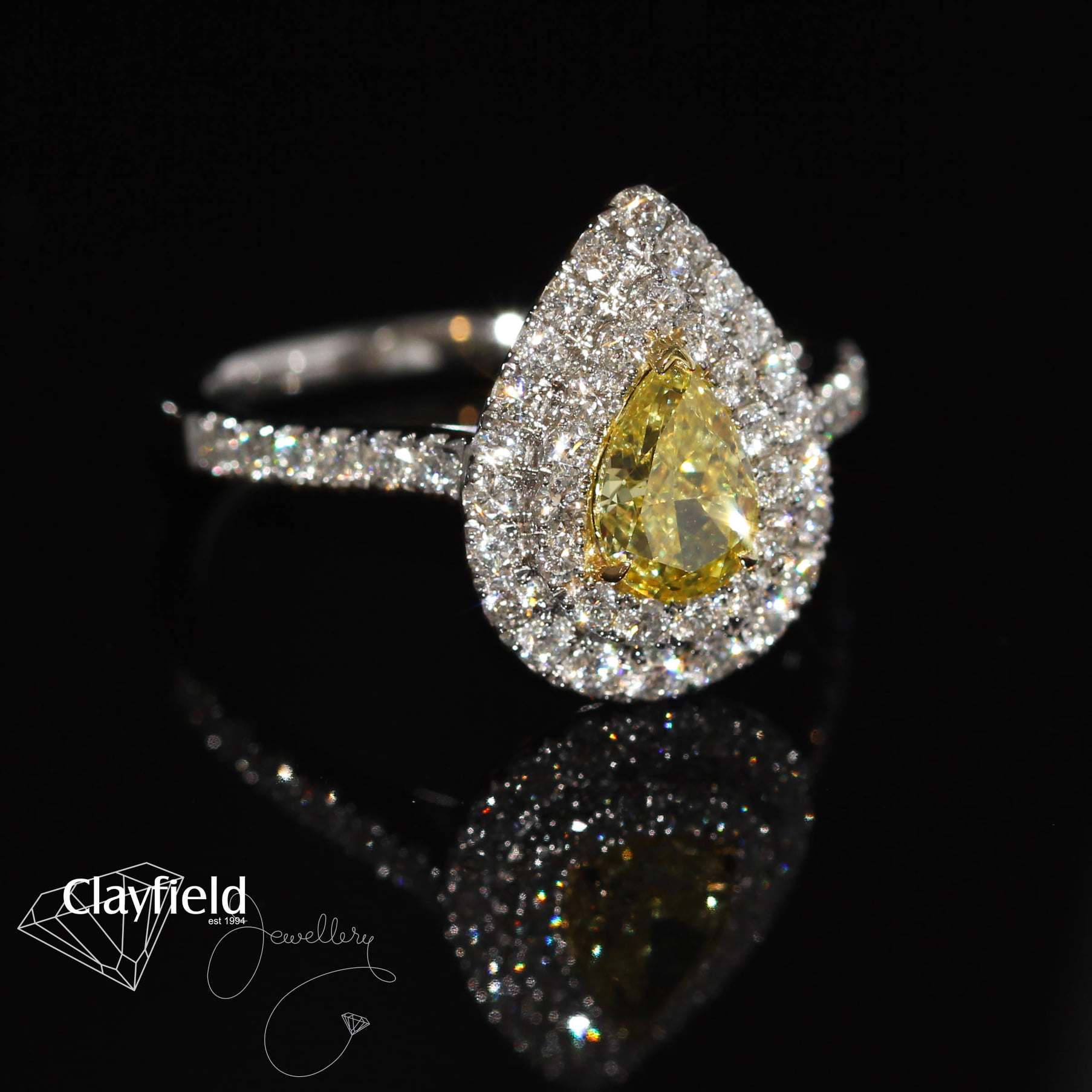 Yellow Diamond, surrounded by .61ct of Diamonds, all set into Platinum & 18ct Yellow Gold
